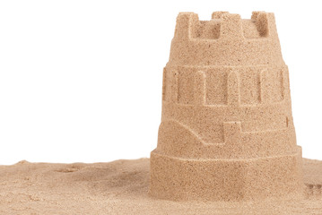 Close up on a sand castle on the beach, isolated on white background. Travel concept. Copy space...