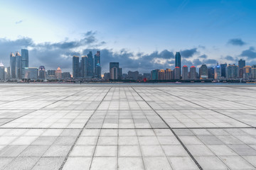 Fototapeta na wymiar Urban skyscrapers with empty square floor tiles