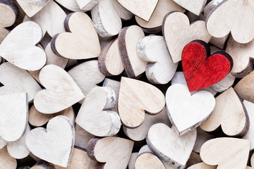 Valentines day background with white end red hearts on wooden background.