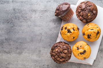 Homemade chocolate muffins on the vintage background.