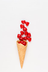 Creative composition for Valentines day with waffle cone, mixed hearts on white background top view. Fashion flat lay.
