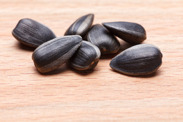 Sunflower seeds on wooden background. Close-up.