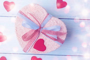Close up of heart shaped gift box in defocused lights.