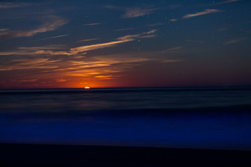 Fototapeta na wymiar Red Moonrise above the sea at twlight