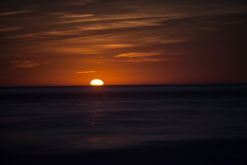 Red Moonrise above the sea at twlight