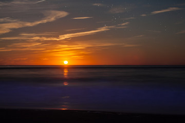 Red Moonrise above the sea at twlight
