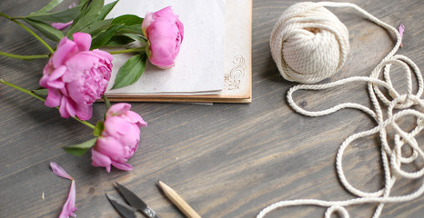 Floral frame with pink peonies on wooden background. Mothers day.