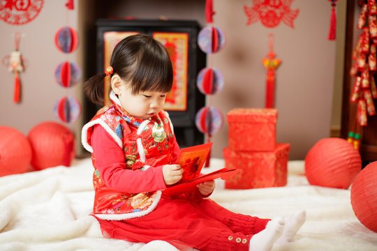 Chinese baby girl  traditional dressing up with a FU means lucky red envelope