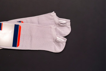 pair of new gray short socks isolated on dark background f