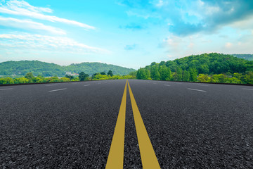 Empty asphalt road and natural landscape under the blue sky