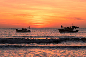 Obraz premium Fishing boats at sunrise on the beach, Brazil