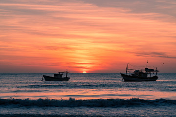 Fishing boats at sunrise on the beach, Brazil