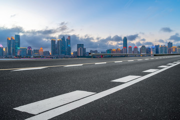 Empty asphalt road along modern commercial buildings in China,s cities