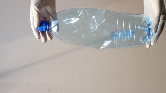 Recycling station, gloved hands sort the bottles