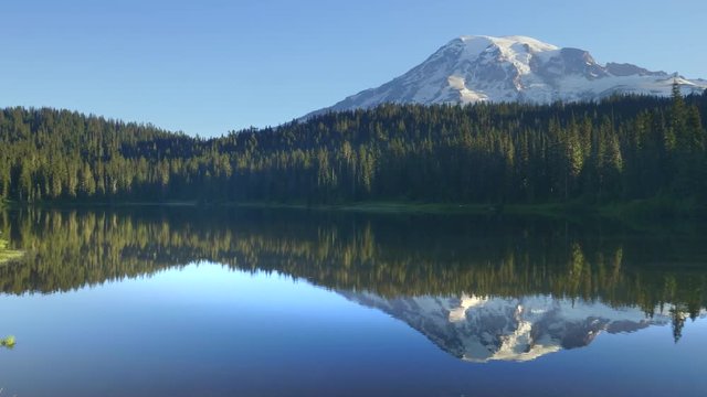 a summer morning pan of mt rainier and reflection lake in washington state of the us pacific northwest