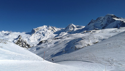 Fototapeta na wymiar Ski slopes and snow-capped mountains in Zermatt, in canton of Wallis, Switzerland.