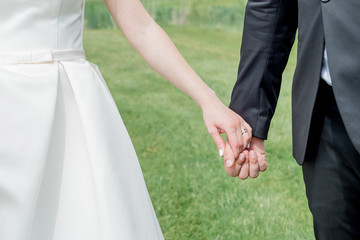 Lovers couple, man and woman walking holding hands. Valentine Day, wedding day or love story background