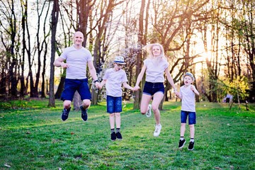 Happy family playing in park at spring