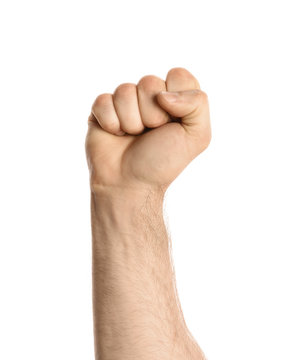 Young man showing clenched fist on white background