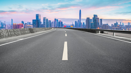 Fototapeta na wymiar Empty asphalt road along modern commercial buildings in China,s cities