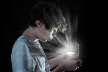 young male open shining wooden box on dark background b