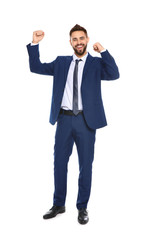 Happy young businessman celebrating victory on white background