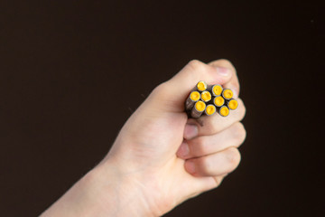 closeup hand hold cracker and fire it on dark background isolated b