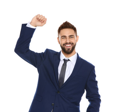Happy young businessman celebrating victory on white background