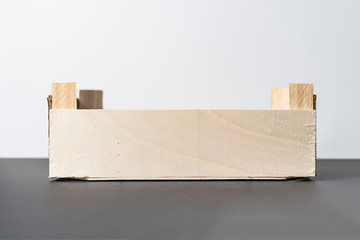 empty wooden crate for food on dark and white background isolated b