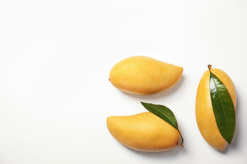 Composition with fresh mango fruits on white background, top view. Space for text