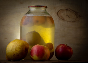 Home-made canned compote and fresh fruit on the basement shelf still life