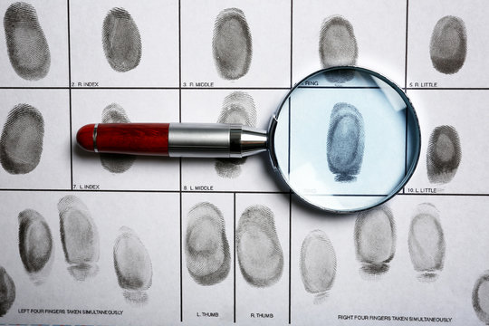 Criminal fingerprint card and magnifier, top view
