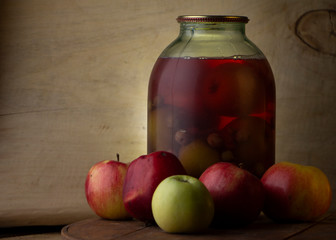 Home-made canned compote and fresh fruit on the basement shelf still life
