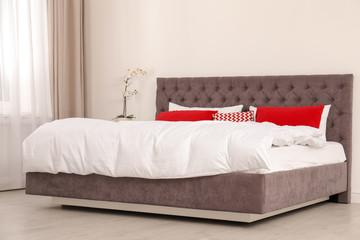 Stylish room interior with comfortable double bed