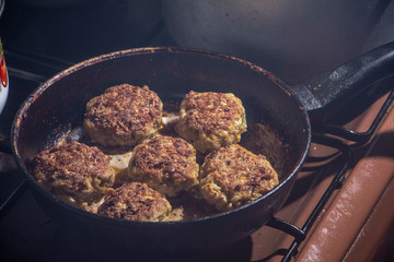 Fresh meat cutlets in a frying pan grill.