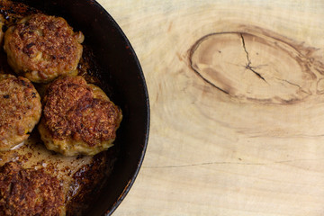 Fresh meat cutlets in a frying pan grill.