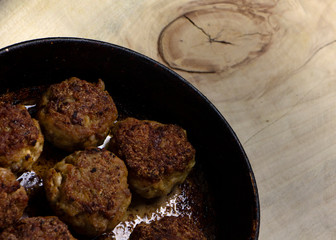 Fresh meat cutlets in a frying pan grill.