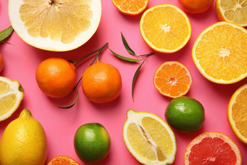 Naklejka na ściany i meble Different citrus fruits on color background, top view
