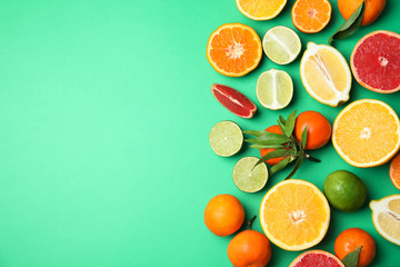 Different citrus fruits on color background, top view. Space for text