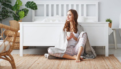 happy young woman having coffee in morning in bed