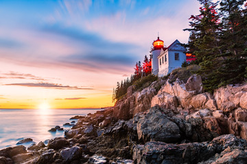 Bass Harbor Head lighthouse at sunset. Bass Harbor Head Light is a lighthouse located within Acadia National Park, Maine, marking the entrance to Bass Harbor and Blue Hill Bay