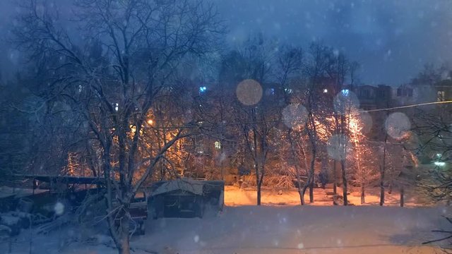 Plotagraph - winter weather on the yard outside, falling snow