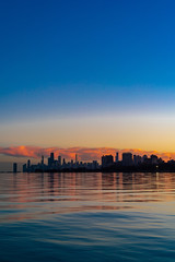 Fototapeta premium Sunset over Chicago on the lake at winter