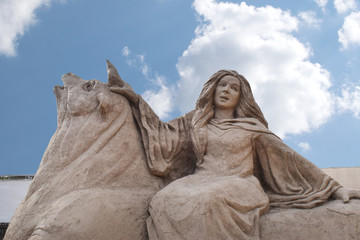 Fototapeta premium Lara Beach, Sandland Sand Sculpture Festival. View of big sand sculpture of mythological characters The Abduction of Europa 