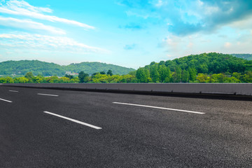 Empty asphalt road and natural landscape under the blue sky