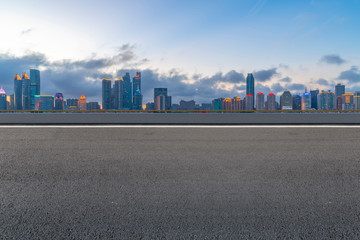Fototapeta na wymiar Empty asphalt road along modern commercial buildings in China,s cities