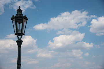 Fototapeta na wymiar Street lamp with blue cloudy sky