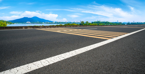 Fototapeta premium Empty asphalt road square and natural landscape under the blue sky