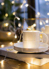 White saucer set with mug and teapot. Festive Christmas layout.