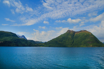 Naklejka na ściany i meble Amazing nature view with fjord and mountains. Beautiful reflection.